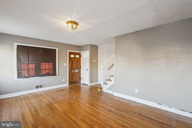 spare room with hardwood / wood-style floors