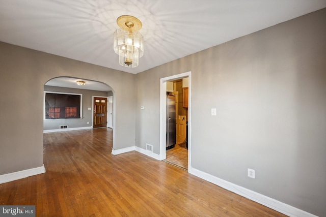 unfurnished room with light wood-type flooring