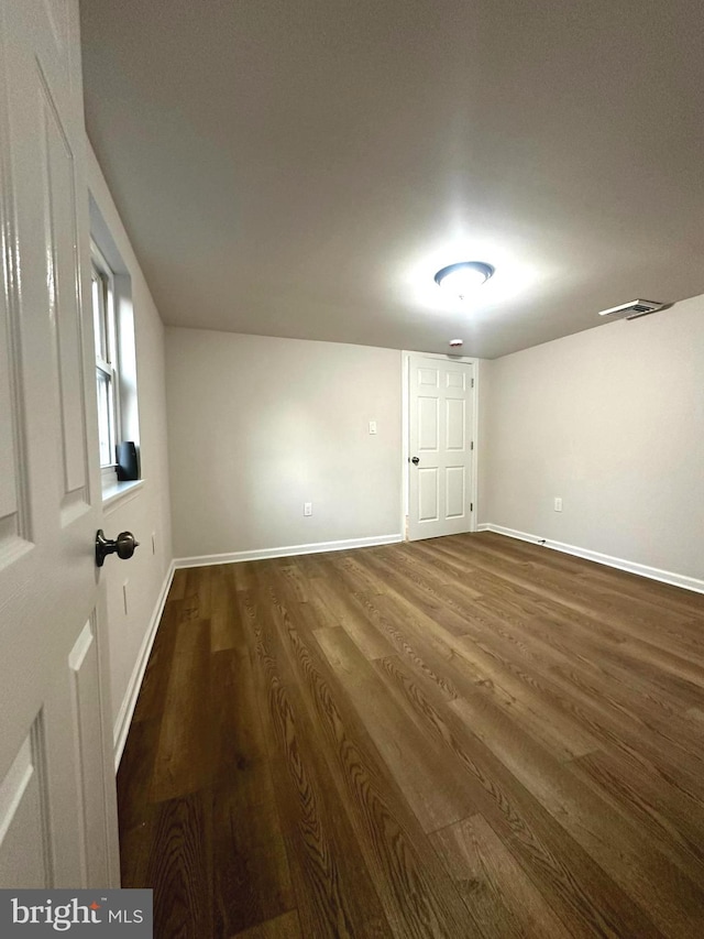 unfurnished room featuring dark hardwood / wood-style flooring