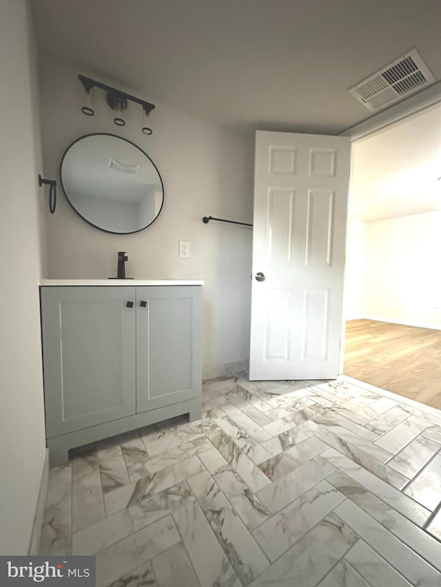 bathroom with vanity and hardwood / wood-style flooring