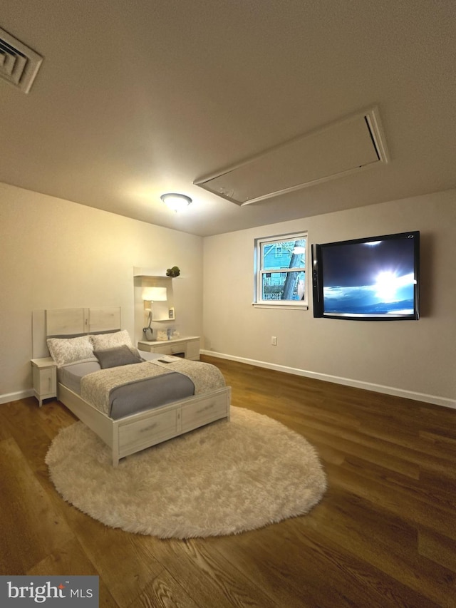 bedroom with dark hardwood / wood-style flooring