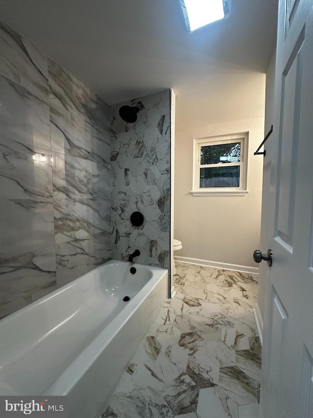 bathroom with toilet and tiled shower / bath combo