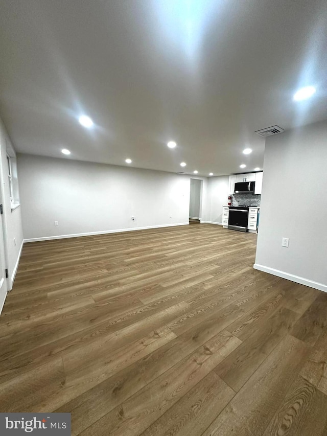 unfurnished living room featuring dark hardwood / wood-style floors