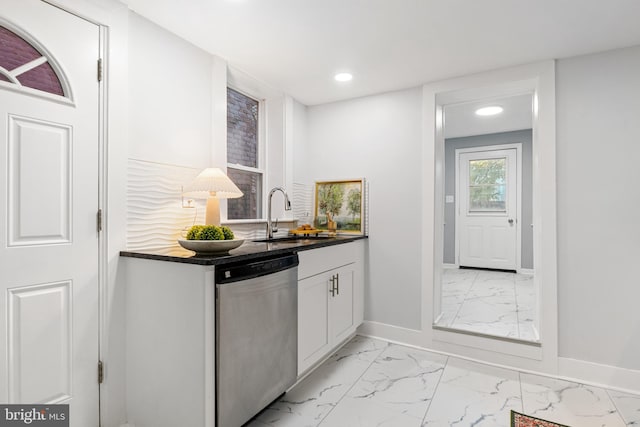 kitchen featuring white cabinetry, sink, and stainless steel dishwasher