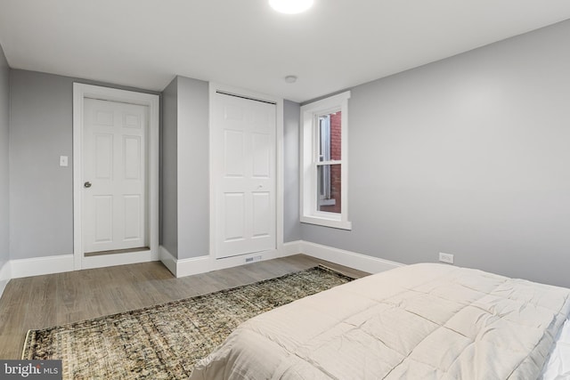 bedroom with a closet and hardwood / wood-style flooring