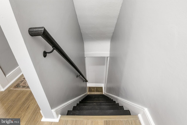 stairs with wood-type flooring