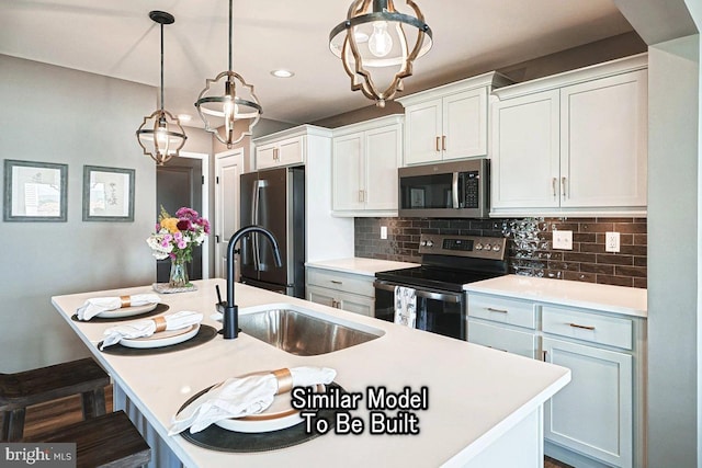 kitchen featuring decorative backsplash, an island with sink, stainless steel appliances, decorative light fixtures, and white cabinets