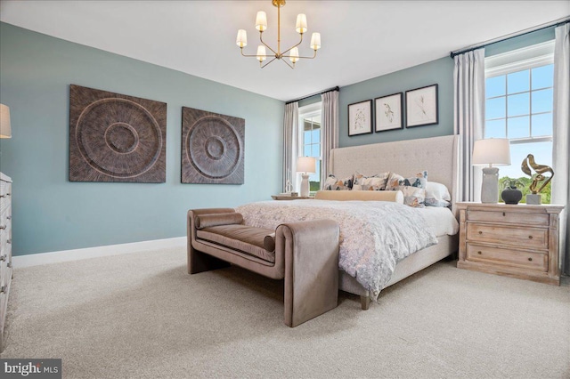 carpeted bedroom with a chandelier