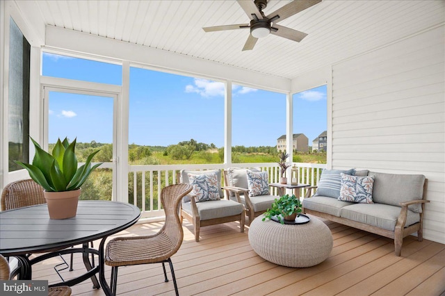 sunroom featuring ceiling fan