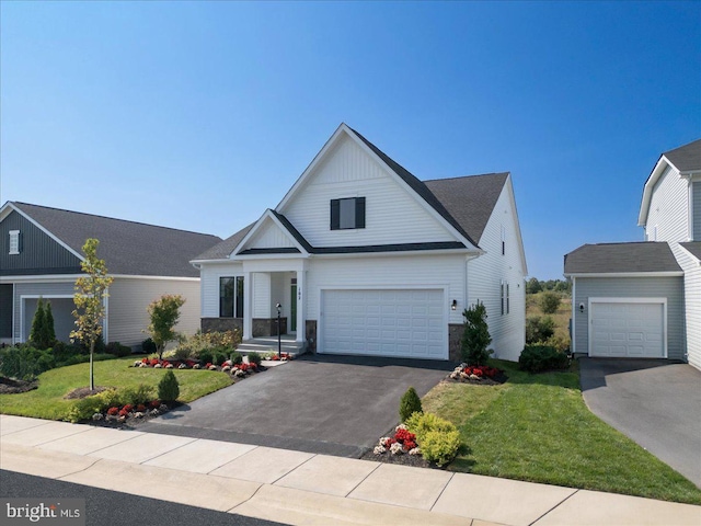 view of front of house featuring a garage and a front lawn