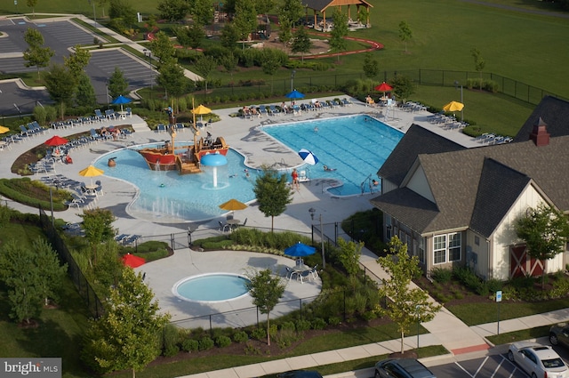 view of swimming pool featuring a hot tub and a patio area