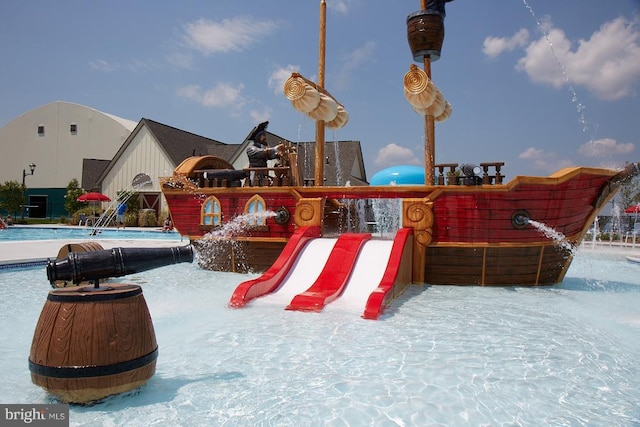 snow covered playground with a community pool and pool water feature