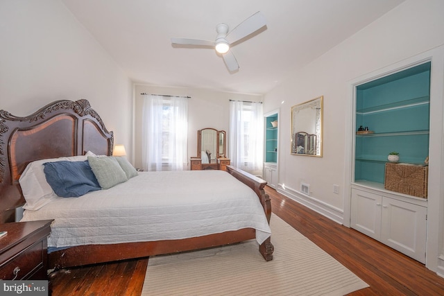 bedroom with dark hardwood / wood-style floors and ceiling fan