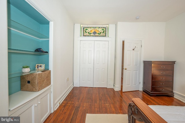 corridor with dark hardwood / wood-style flooring