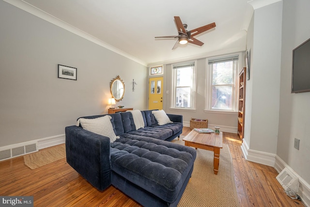 living room with crown molding, hardwood / wood-style flooring, and ceiling fan