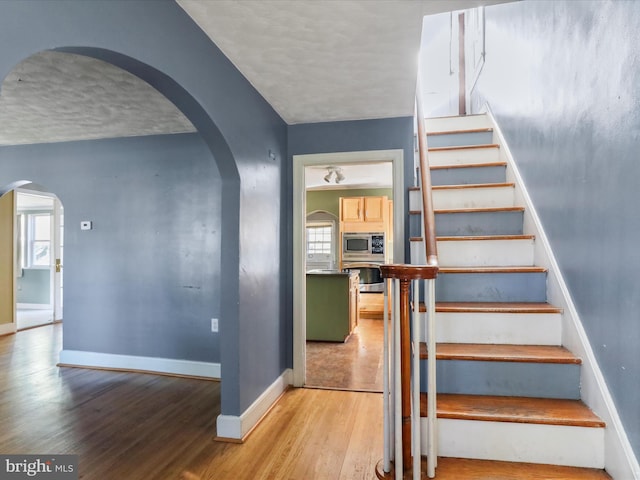 stairway featuring wood-type flooring