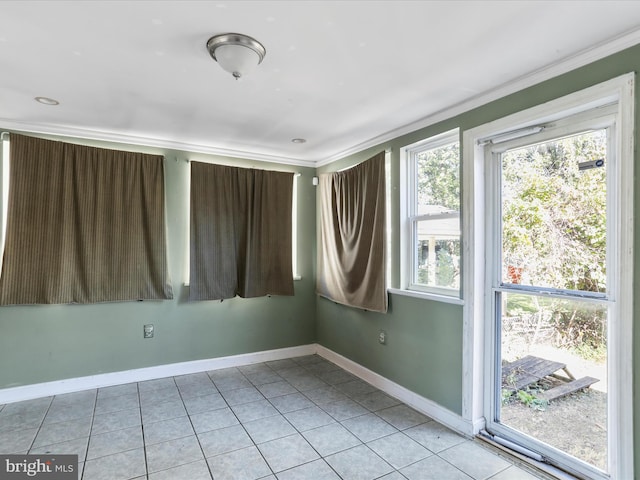 tiled spare room featuring ornamental molding