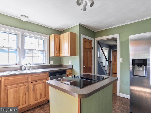 kitchen featuring appliances with stainless steel finishes, ornamental molding, a center island, and sink