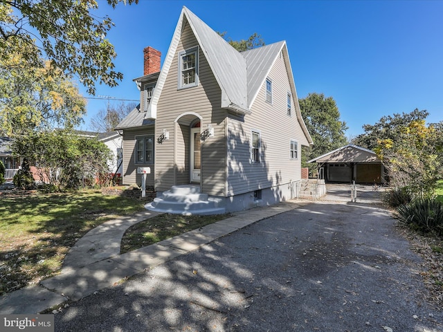 view of front of property with a carport and a front lawn