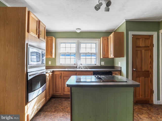 kitchen featuring appliances with stainless steel finishes, sink, and a kitchen island