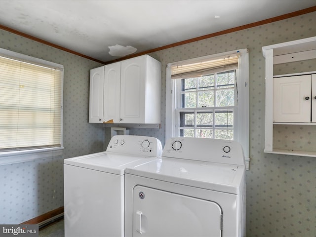 clothes washing area with crown molding, cabinets, and washer and clothes dryer