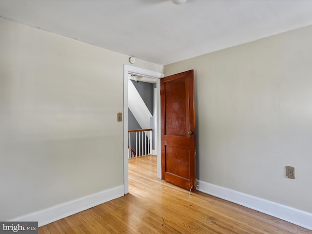 empty room with light hardwood / wood-style flooring