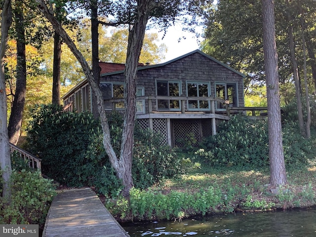 back of house featuring a deck with water view