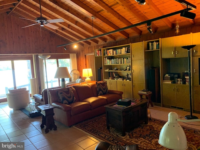 tiled living room featuring lofted ceiling with beams, wood walls, wood ceiling, and ceiling fan