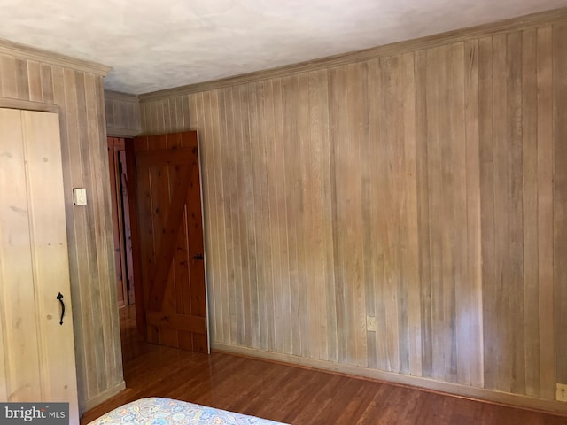 unfurnished bedroom featuring light hardwood / wood-style floors and wooden walls