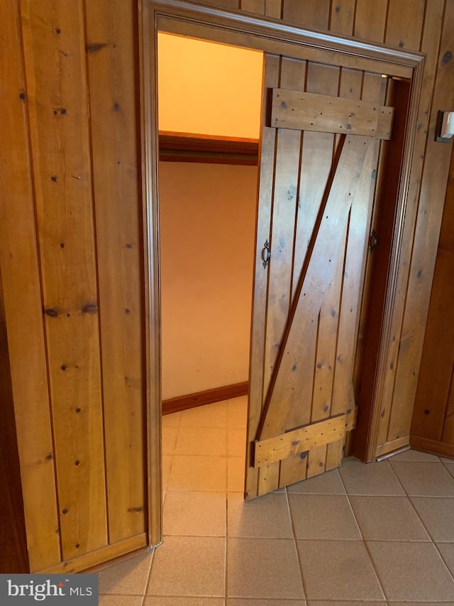 interior details featuring tile patterned floors and wood walls