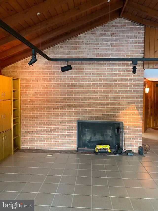 unfurnished living room with tile patterned floors, wood walls, lofted ceiling with beams, and wooden ceiling