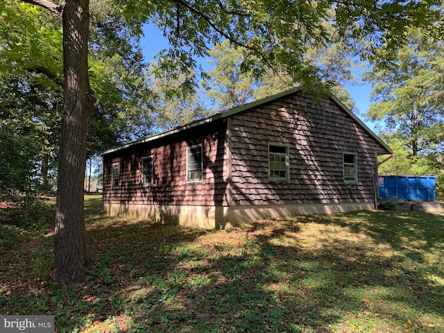 view of property exterior with a yard