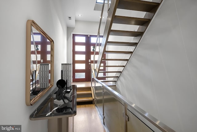 stairs featuring hardwood / wood-style flooring