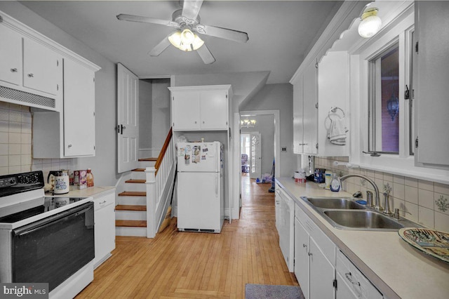 kitchen featuring decorative backsplash, light wood-type flooring, white appliances, and sink