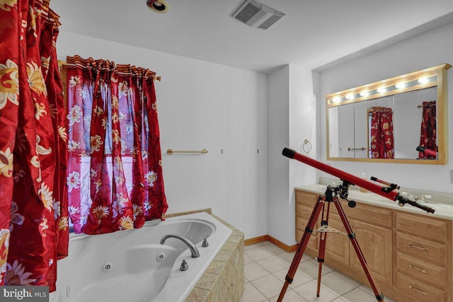 bathroom with tile patterned flooring, vanity, and tiled tub