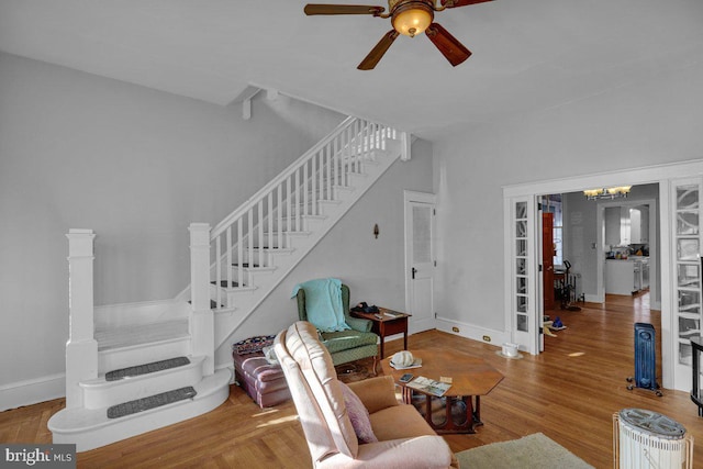 161 W High St, Womelsdorf, PA 19567 - living area with stairway, a ceiling fan, and wood finished floors