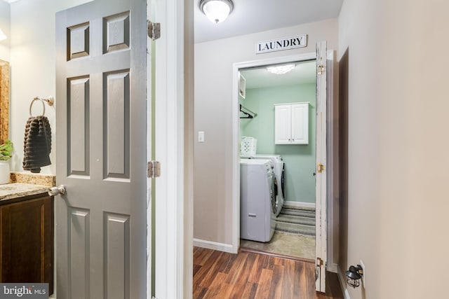 corridor with washer and clothes dryer and dark wood-type flooring