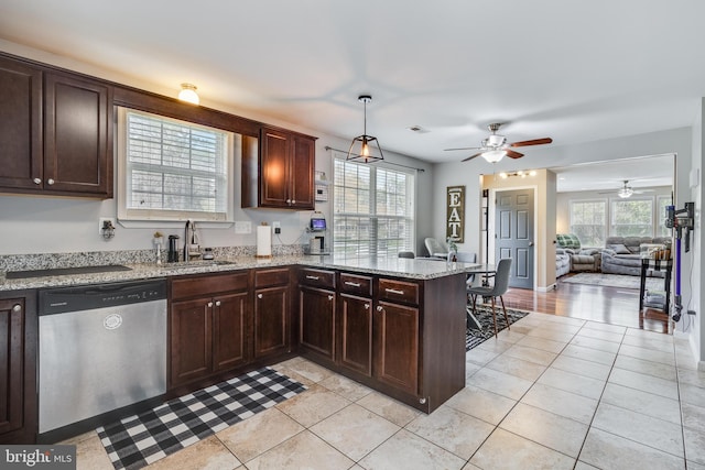 kitchen with kitchen peninsula, stainless steel dishwasher, sink, pendant lighting, and light tile patterned floors