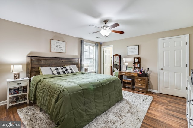 bedroom with ceiling fan and dark wood-type flooring