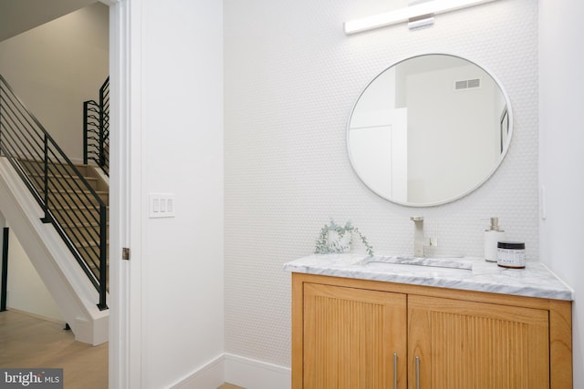 bathroom with vanity and wood-type flooring