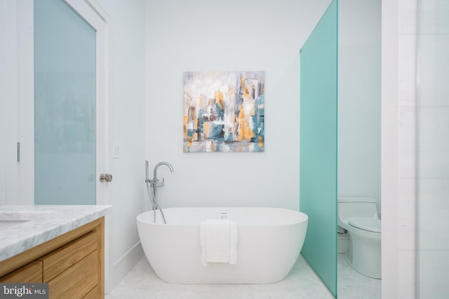 bathroom featuring a tub, tile patterned flooring, vanity, and toilet