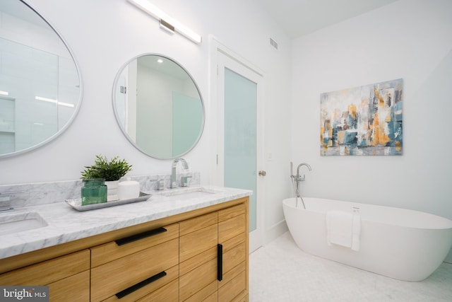 bathroom with vanity and a bathtub