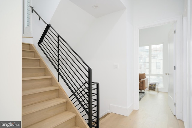 staircase featuring wood-type flooring