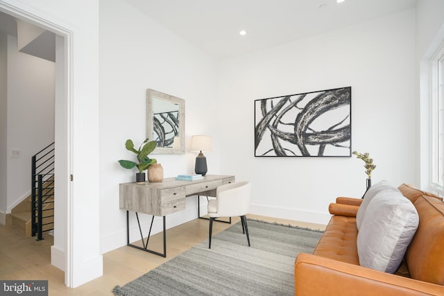 home office with light hardwood / wood-style floors