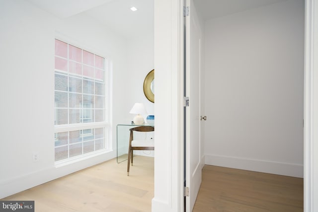 hallway with light hardwood / wood-style floors