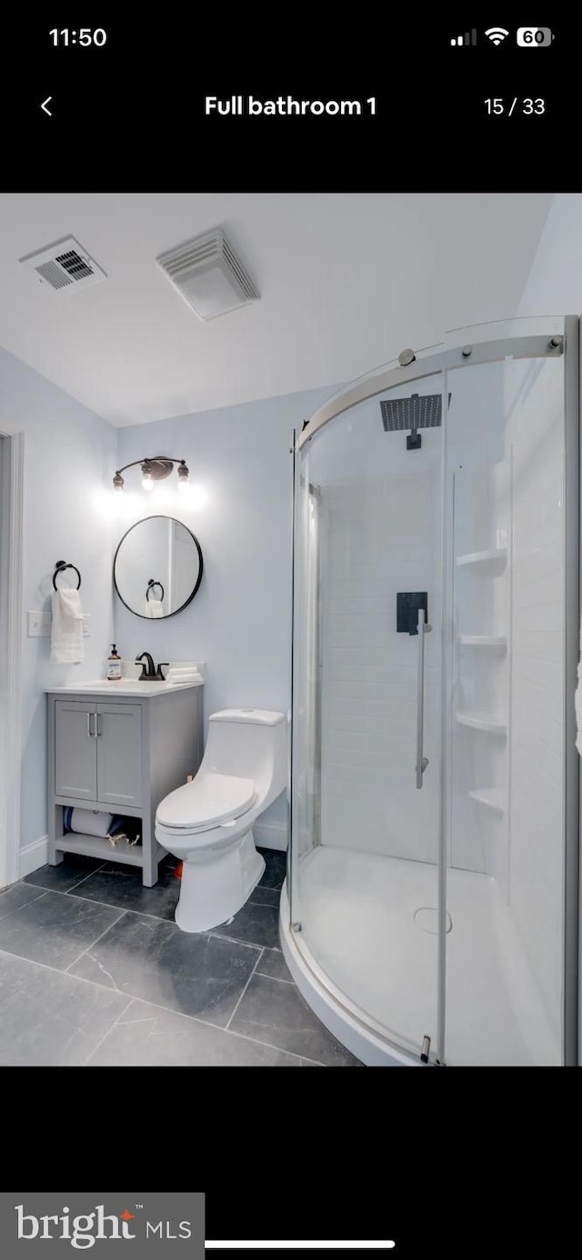 bathroom with walk in shower, vanity, and toilet