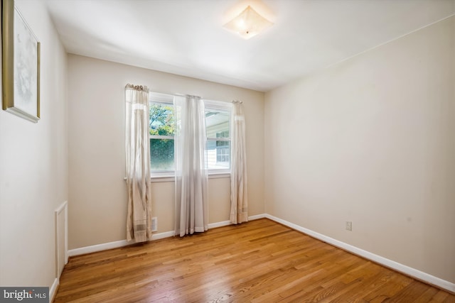 unfurnished room with light wood-type flooring