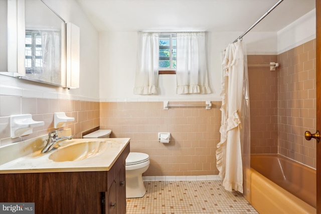 full bathroom featuring shower / tub combo, vanity, tile walls, tile patterned floors, and toilet