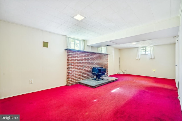 basement with carpet and a wood stove