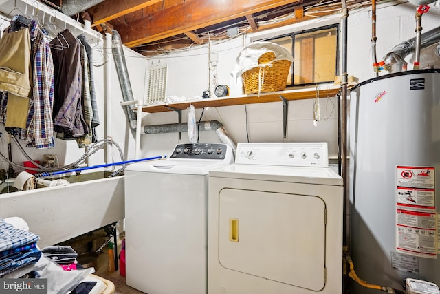 laundry room featuring washer and clothes dryer, gas water heater, and sink